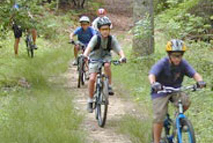 Children bicycling a course at camp