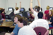 Students asking questions in summer computer classes