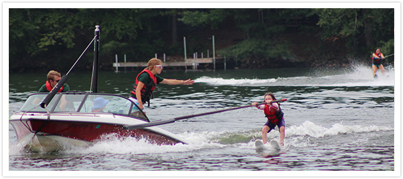 A summer camp girl learning to water ski. On The Summer Lady Website.