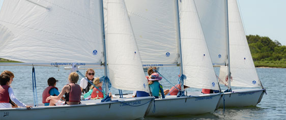 Children enjoying sailing instruction at summer sailing camp